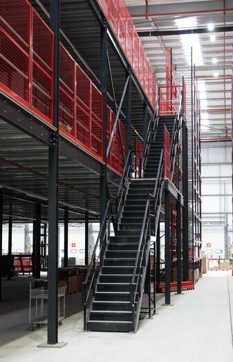 Multi-tier mezzanine completed in black finish with read handrail and black stairs