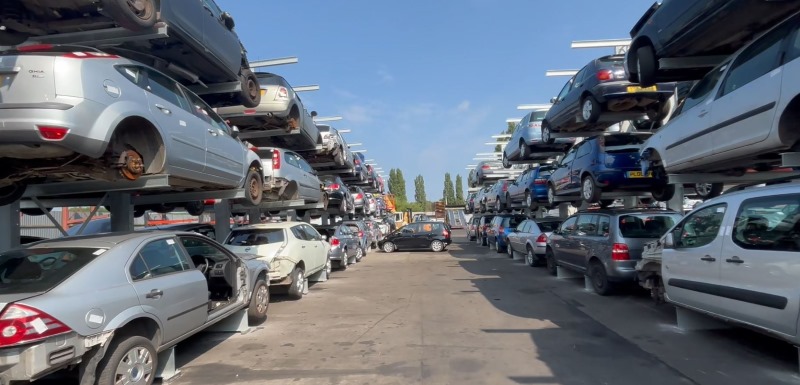 Vehicle dismantlers yard with Wickens car racks on both sides